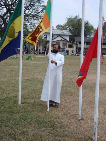 Rev. Bro. Denzil Mendis raising the national flag